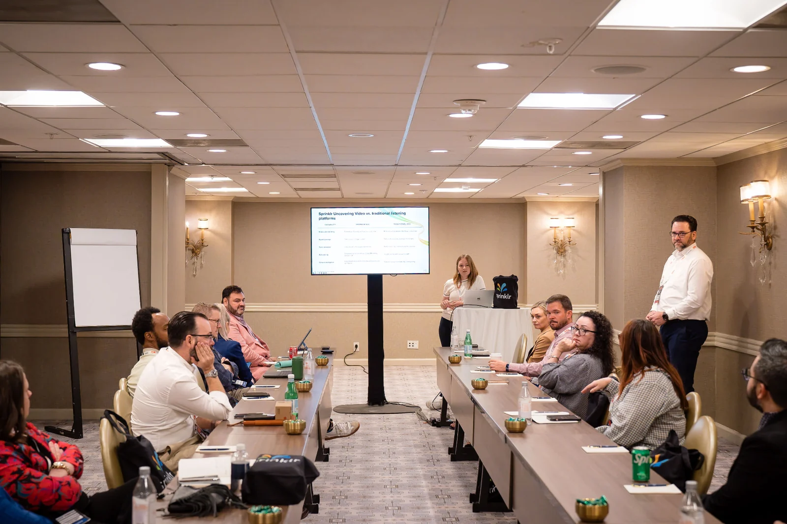 Elizabeth Arnold leading a workshop with participants seated around conference tables